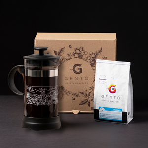 french press and a bag of coffee with a gift box